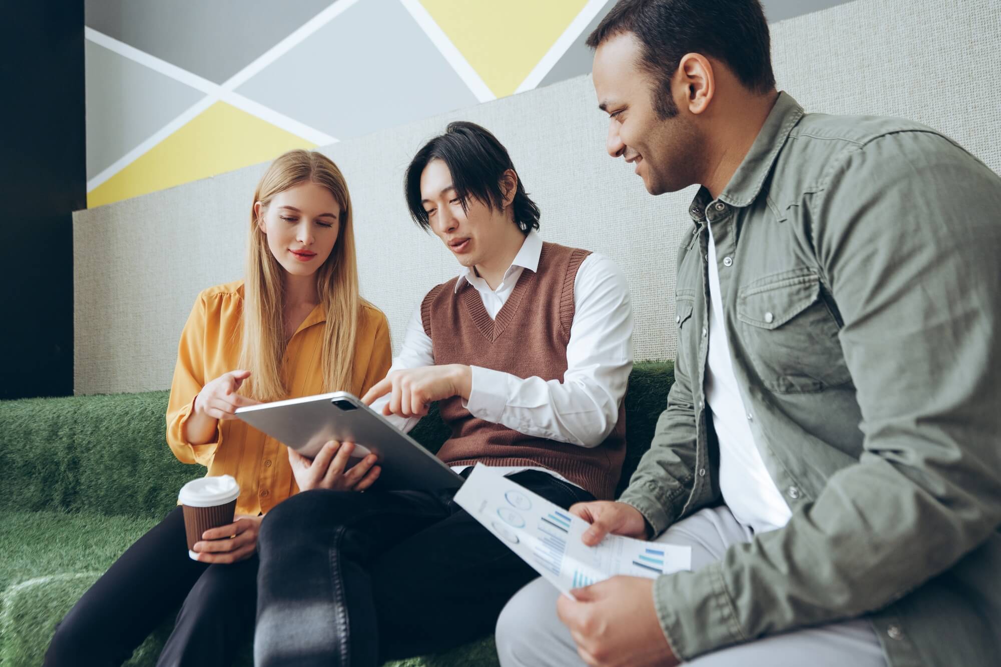 marketing-team-analyzing-data-and-working-on-digital-tablet-and-documents.jpg